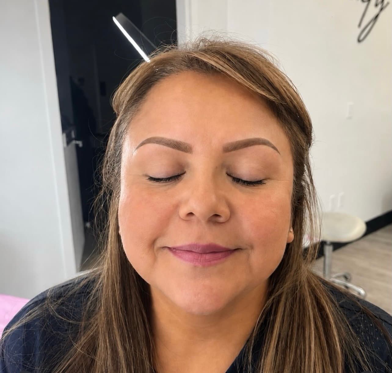 Client with defined, arched brows by Trey, eyes gently closed